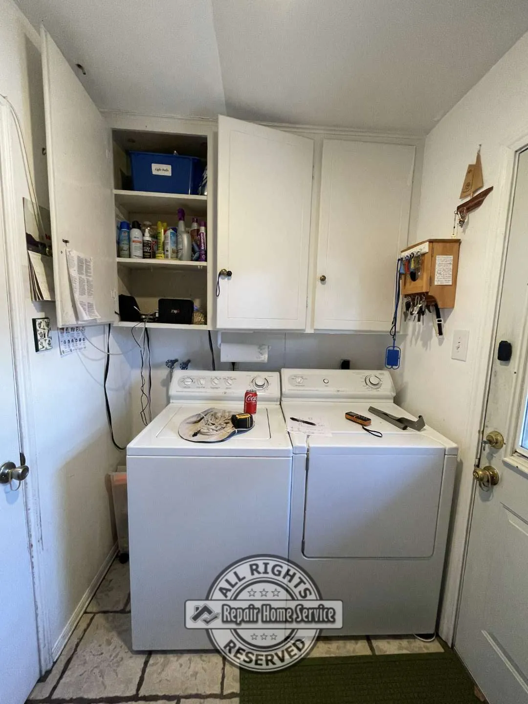 Custom floor-to-ceiling cabinet framework under construction inside Houston laundry room with open shelving layout.