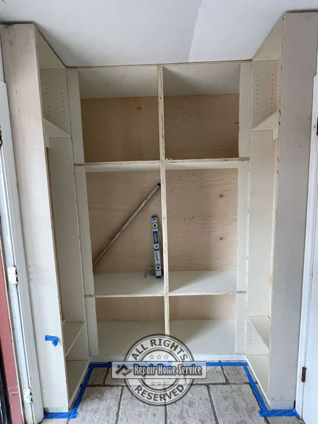 Interior view of custom storage cabinet showing adjustable shelving and pull-out storage components.