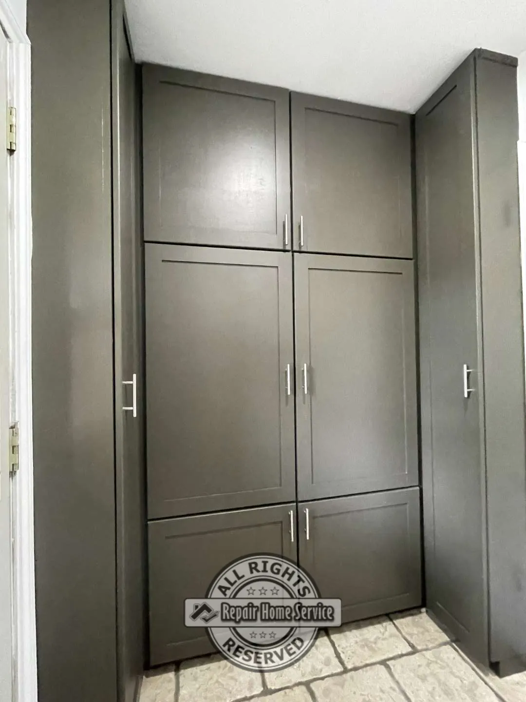 Tall custom utility cabinet with integrated shelving and concealed storage beside laundry appliances.