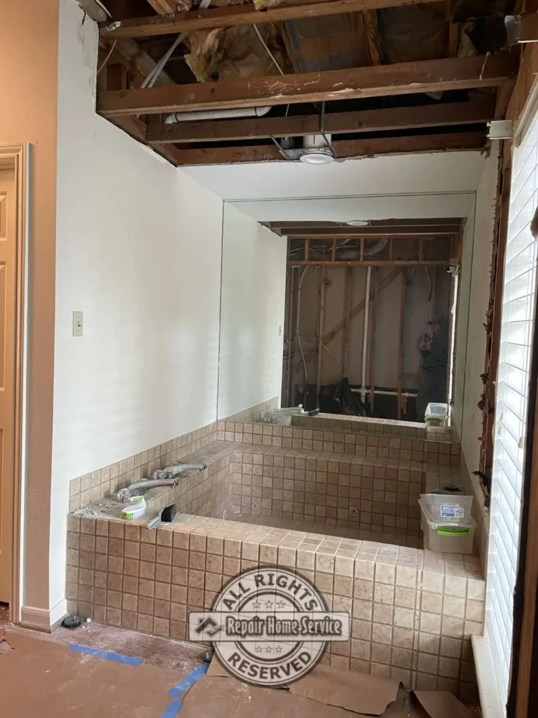 Bathroom remodel construction progress with exposed wall framing and plumbing preparation in Houston area home