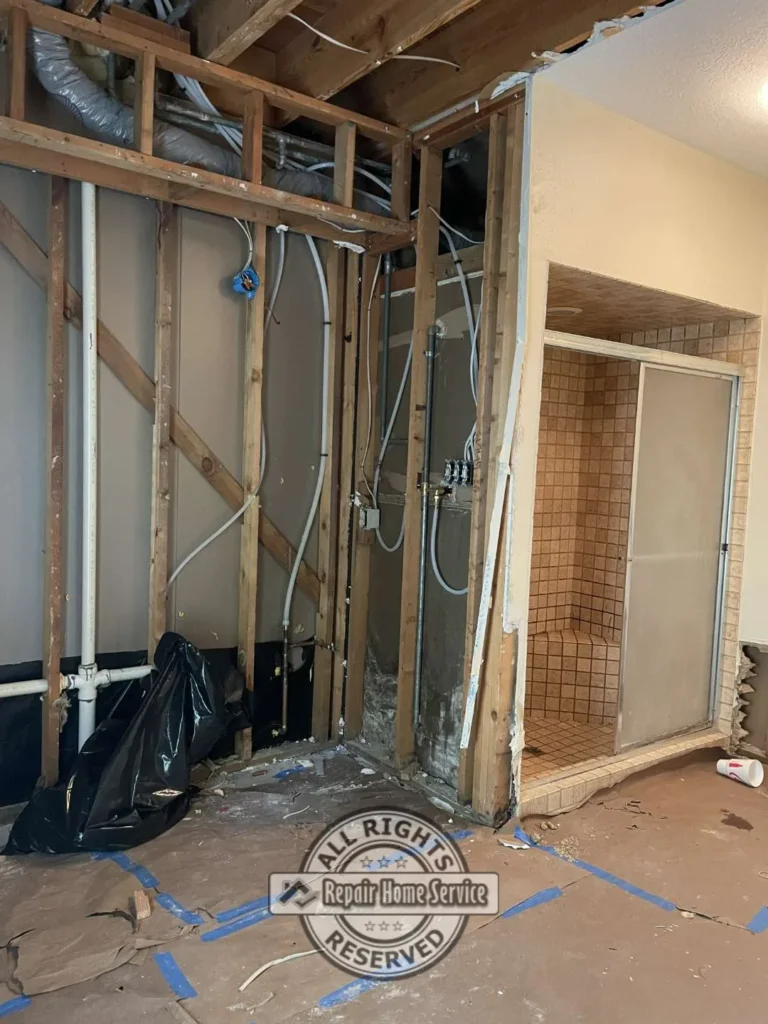 Bathroom demolition phase showing removal of oversized Roman bathtub during remodel project in Houston TX