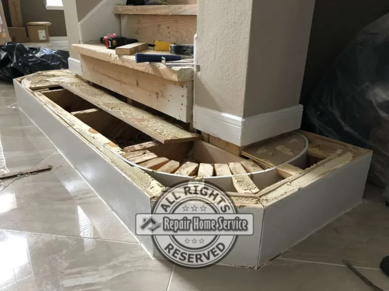 On-site custom framing for a curved wrap-around starter step with white-painted riser base and carpentry tools on unfinished plywood treads in a Cypress TX stair remodel.