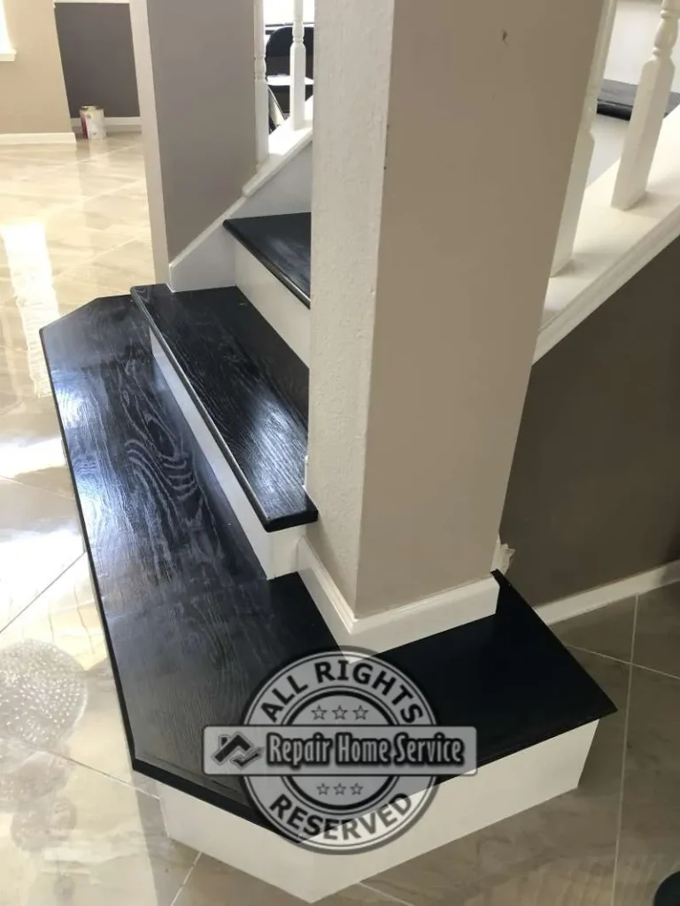 Close detail of precision-cut Black Coffee Red Oak treads, white maple risers, and white baseboard trim where stairs wrap a structural column in Cypress TX.