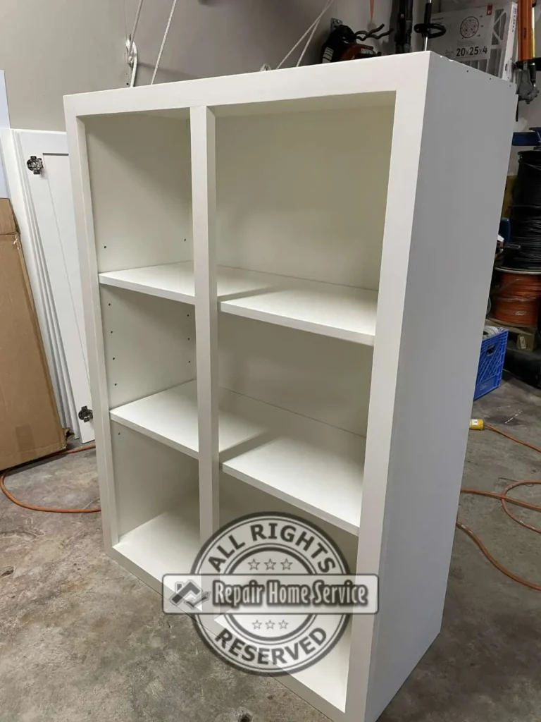 Freestanding white gloss-painted built-in bookcase with adjustable shelf pin holes, built from poplar and plywood for a Cypress TX craft room project.