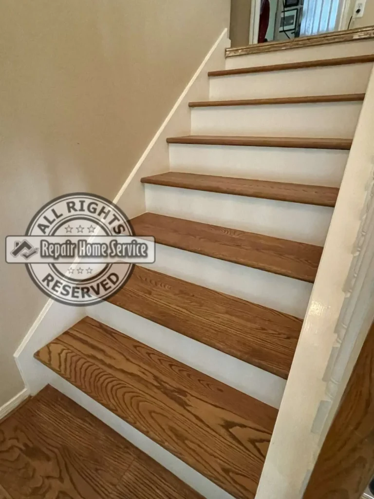 Finished red oak stair treads with white maple risers after remodel in Houston TX 77064, matching the earlier before angle