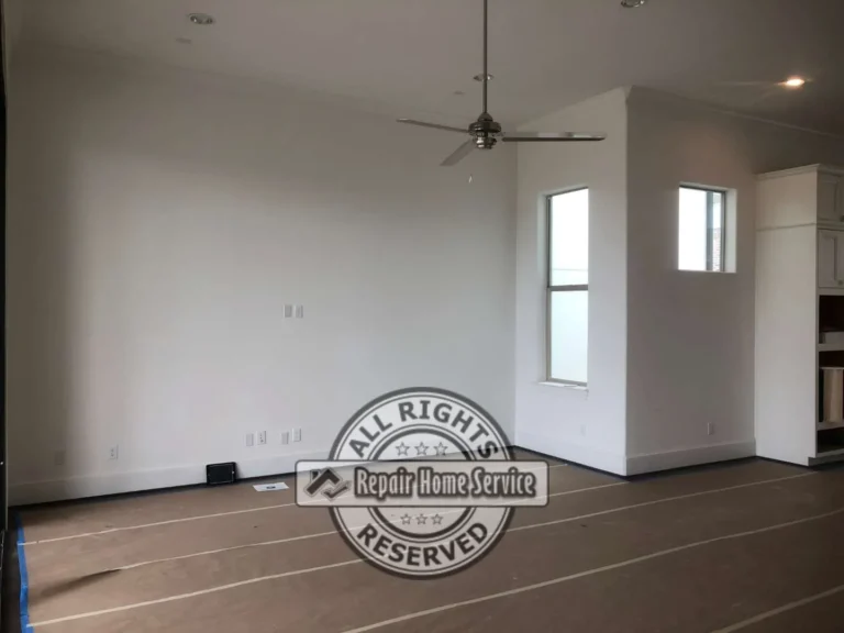 Living room before custom carpentry work showing blank wall area selected for built-in entertainment shelving and storage cabinets