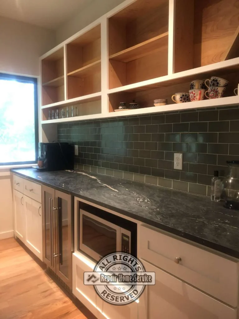Close-up of painted custom cabinet finish and soapstone countertop detail in Houston TX home
