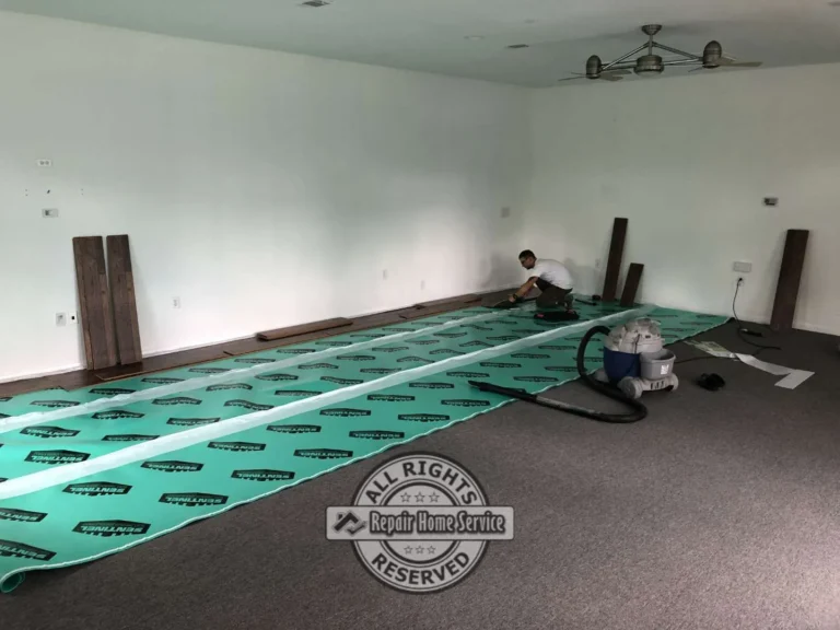 Commercial office flooring installation in progress with acoustic underlayment and luxury vinyl plank flooring being installed inside a future State Farm insurance office in Houston TX.