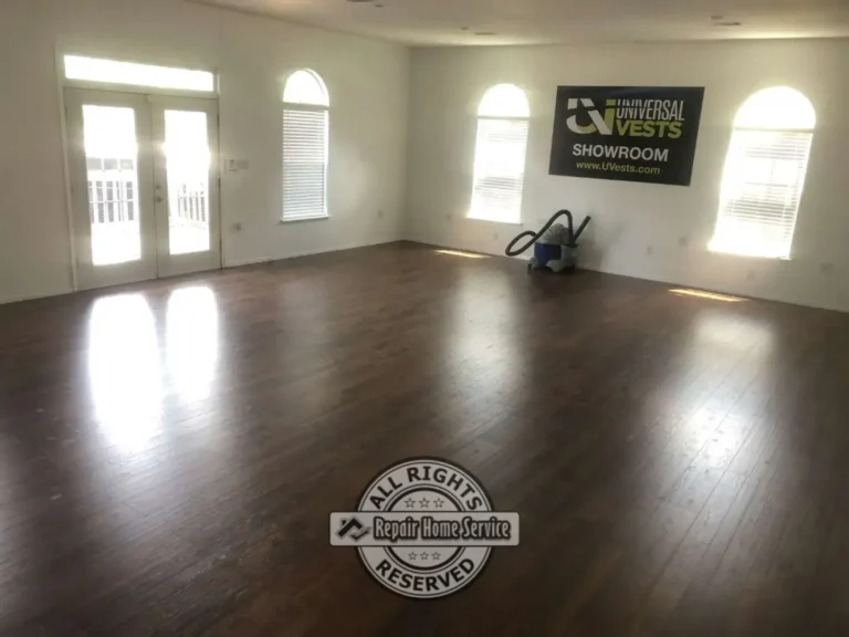 Open showroom space before office renovation featuring hardwood flooring, arched windows, and large open floor plan prior to commercial office build-out in Houston Texas.