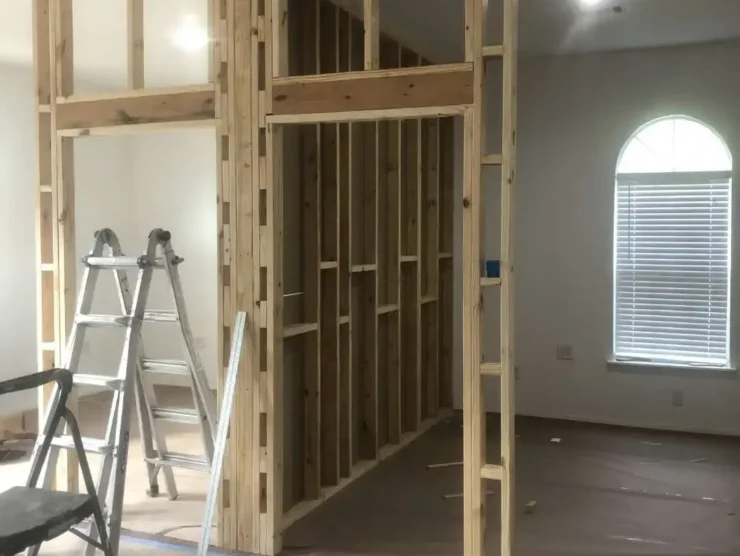 Close-up view of newly framed office partition walls and doorway openings during commercial office build-out and remodeling project.
