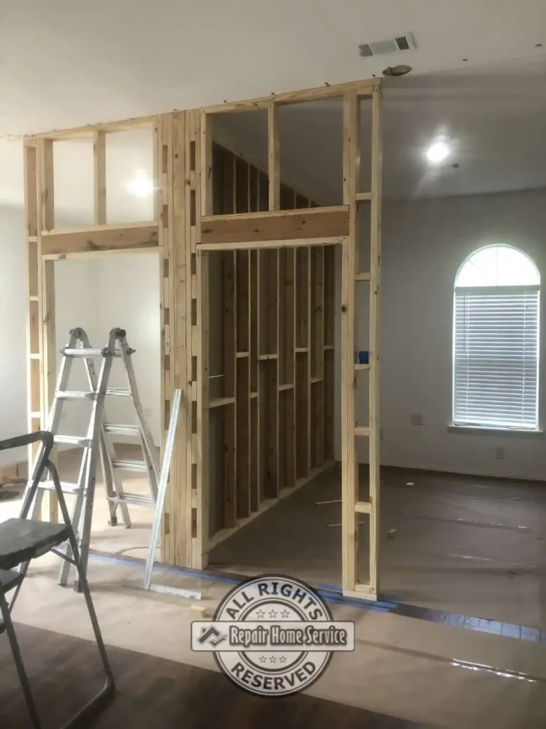 Close-up view of newly framed office partition walls and doorway openings during commercial office build-out and remodeling project.