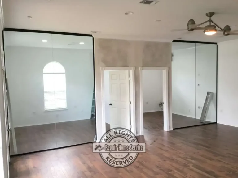 Completed office build-out featuring floor-to-ceiling glass wall systems, private office entrances, hardwood flooring, and modern commercial interior finishes in Houston TX.