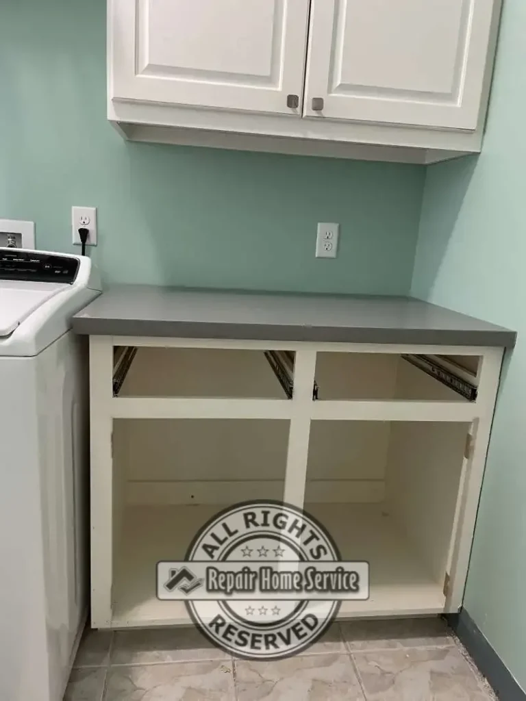 Laundry room base cabinet framing and countertop before installation of custom drawers and freezer accommodation modifications in Spring Texas.