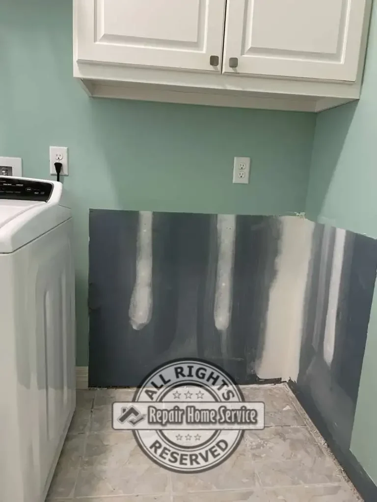 Laundry room cabinet modification showing selective demolition and preparation work prior to custom carpentry and cabinet reconstruction.
