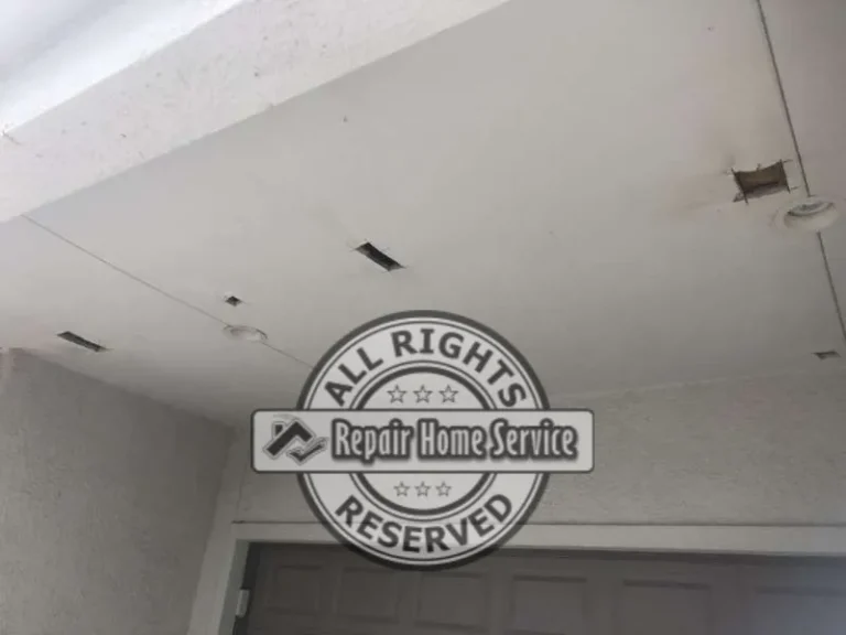 Interior view of front porch ceiling with recessed light fixture where water leakage was first observed in Houston TX home.