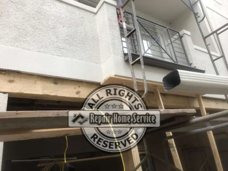 Exterior scaffolding access used for front beam replacement and upper patio waterproofing repairs.