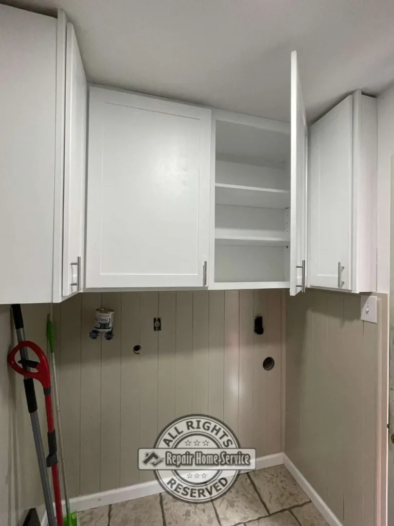 Built-in upper storage cabinets with adjustable shelving designed to maximize laundry room organization.