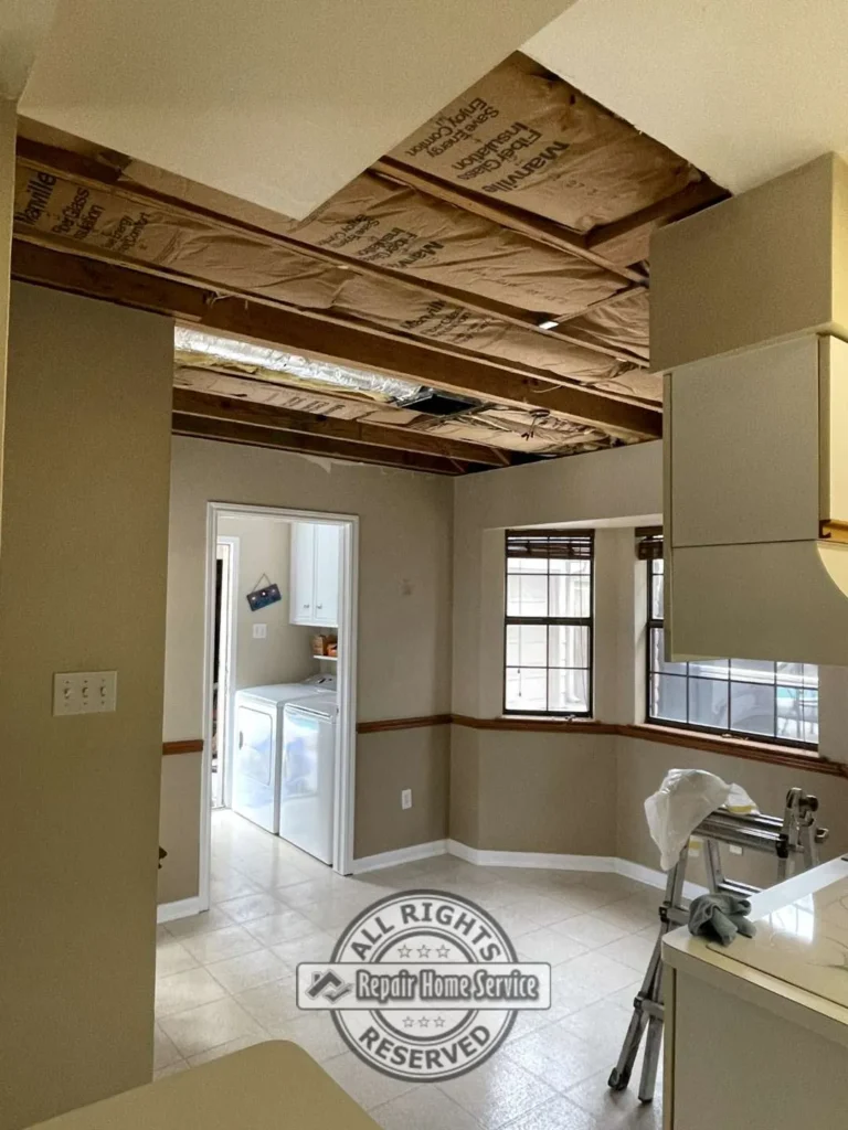 Open ceiling structure with exposed insulation and framing during residential ceiling restoration project in Houston TX living area.