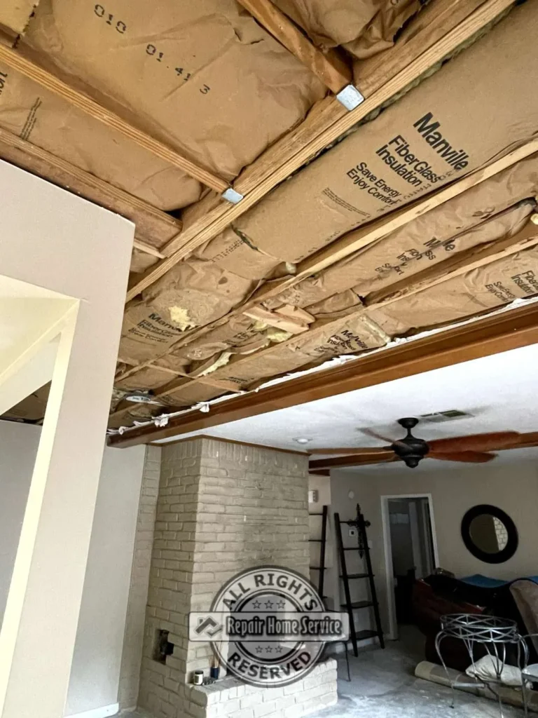 Exposed ceiling framing and electrical wiring during storm damage ceiling restoration inside Houston TX residence.