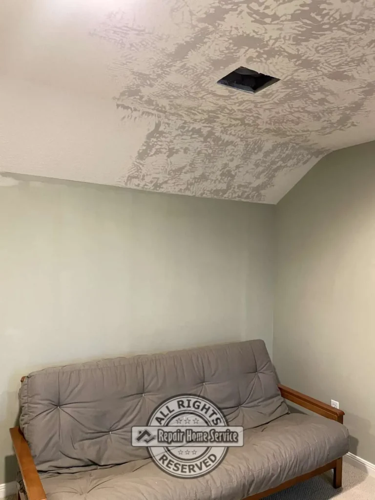 Bedroom ceiling repair after Sheetrock patching with blended texture work around a ceiling vent opening above a futon and painted walls.